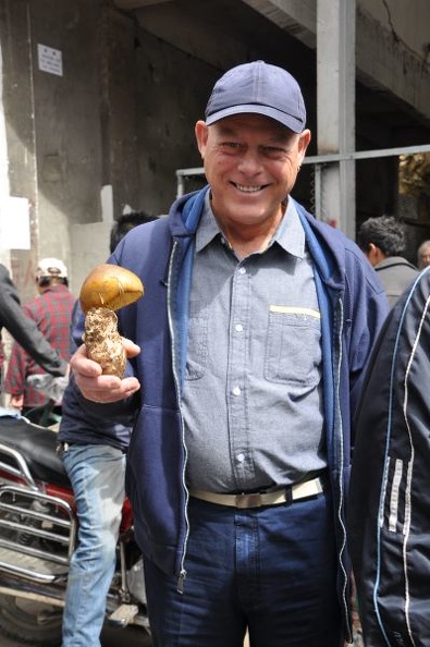 Joe holding an Amanita hemibapha, a Himalayan Caesar mushroom.